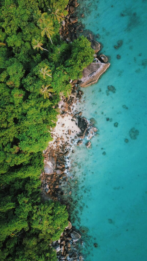 Aerial view of Perhentian Islands Malaysia with turquoise sea, white sandy beach, and lush tropical forest