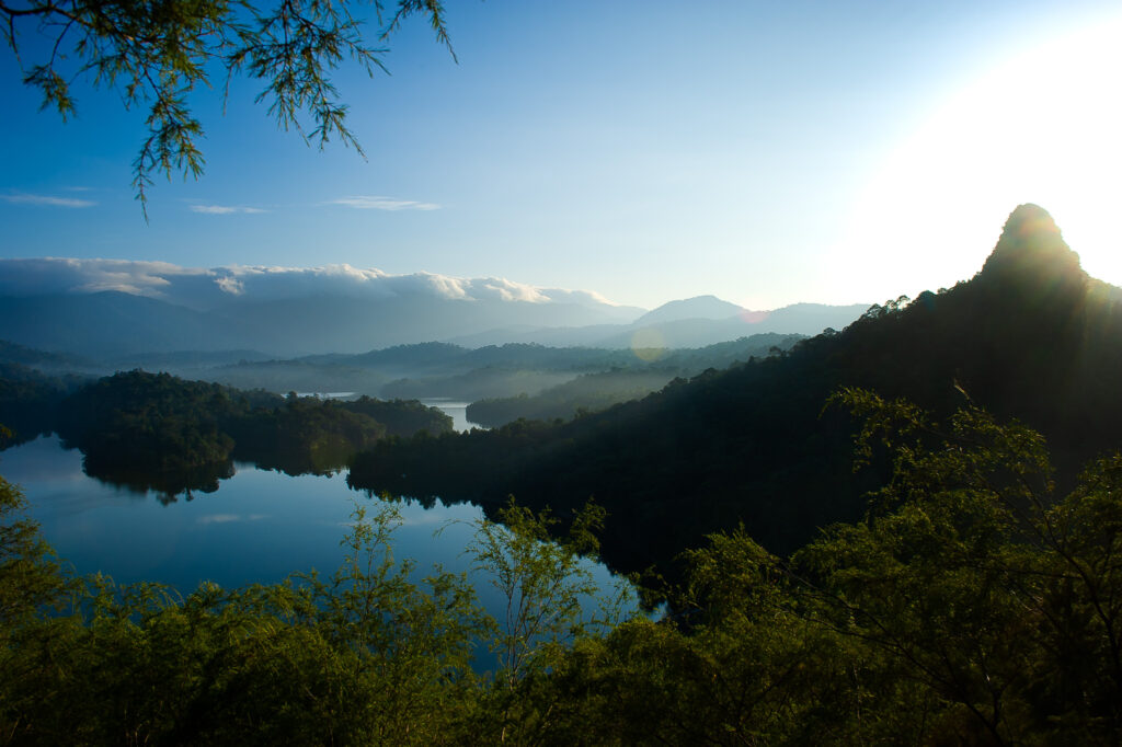 View of Taman Negara National Park with rainforest, mountains, and river at sunrise in Malaysia