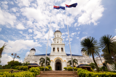 Sultan Abu Bakar State Mosque in Johor Bahru Malaysia with Victorian-Islamic architecture and Malaysian flags