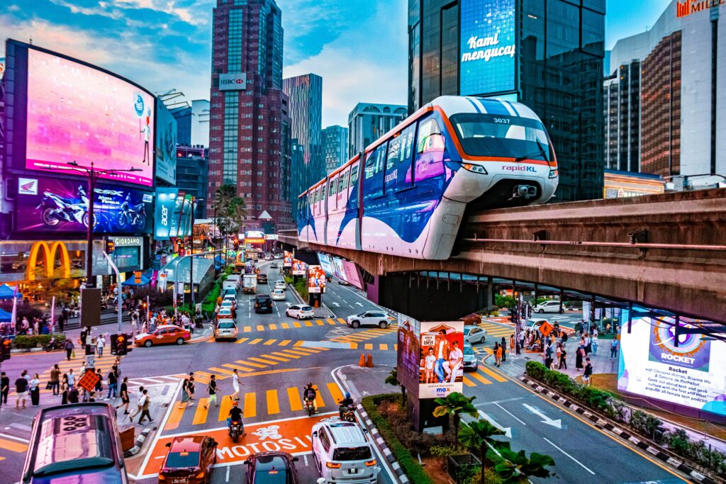 Kuala Lumpur monorail passing above Bukit Bintang busy city street