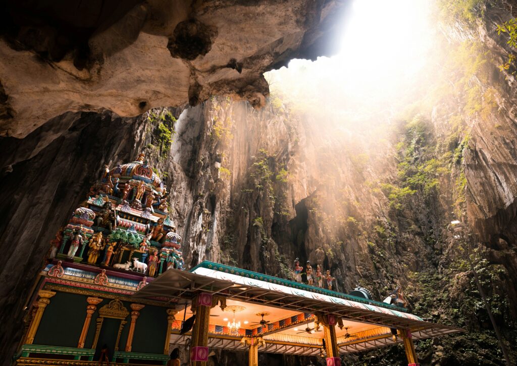 Batu Caves Hindu temple with sunlight shining into limestone cave in Kuala Lumpur